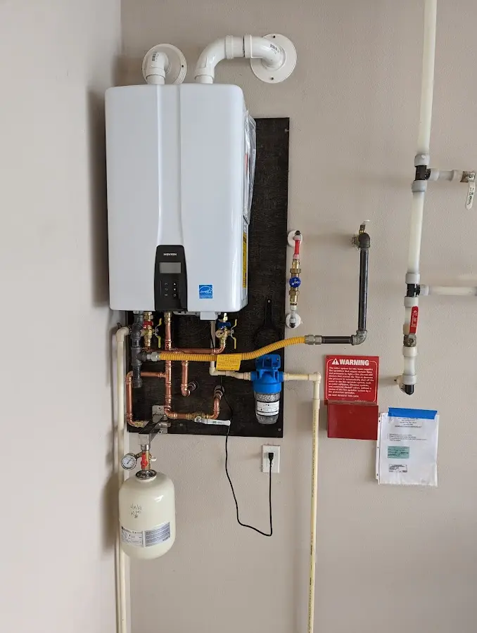 Professional plumber installing copper piping in a Foley home